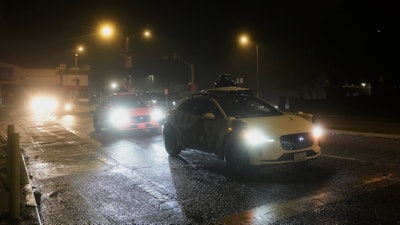 A Waymo vehicle sits idling at an intersection with no operating traffic lights due to power outages, in San Francisco, Saturday, Dec. 20, 2025.