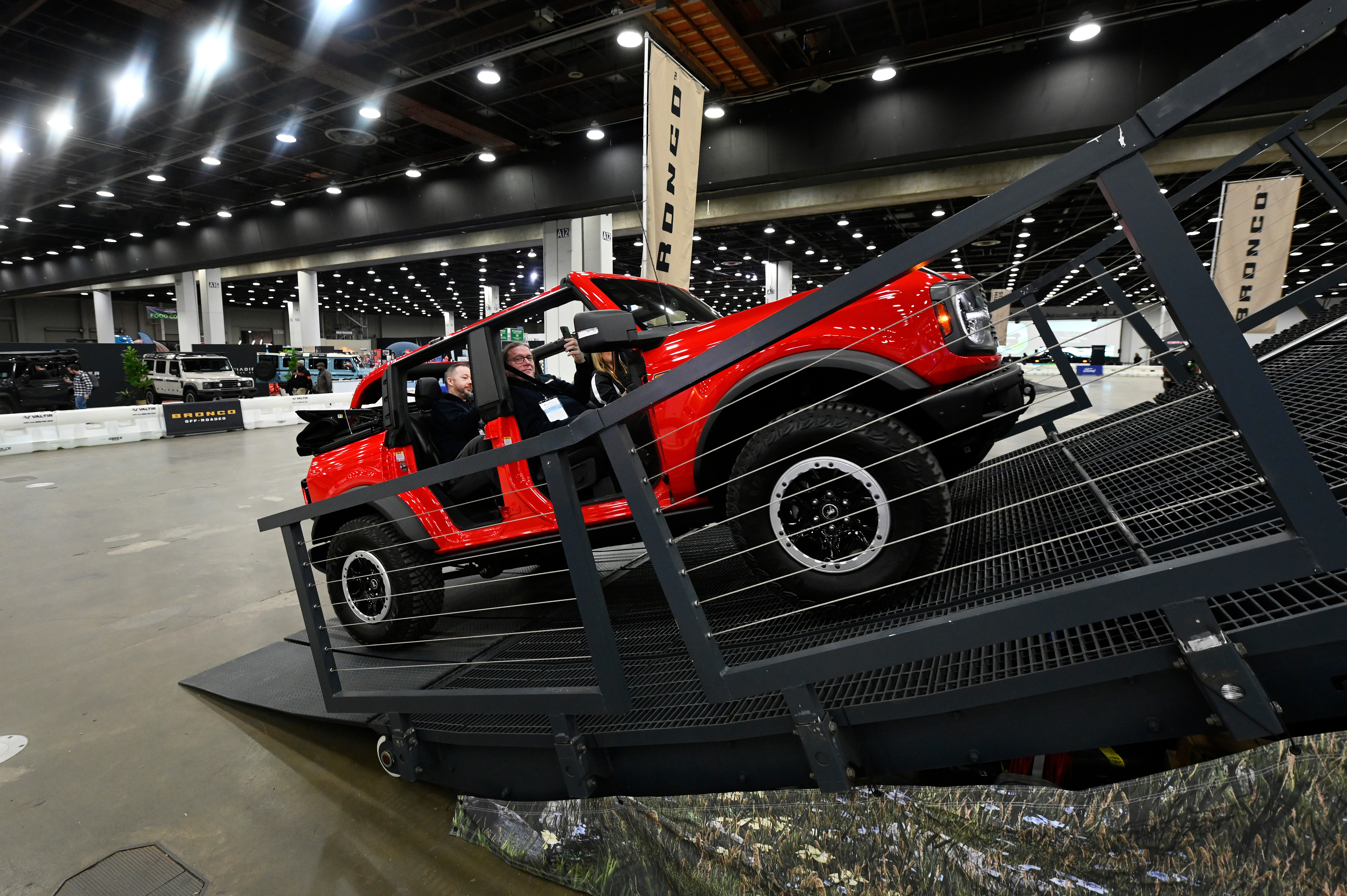 Guests are given a ride in a Bronco on a track at the Detroit Auto Show, Friday, Jan. 10, 2025, in Detroit.
