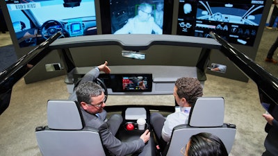 People experience a Gentex Corporation driver and in-camera monitoring system exhibit during the CES tech show Tuesday, Jan. 6, 2026, in Las Vegas.
