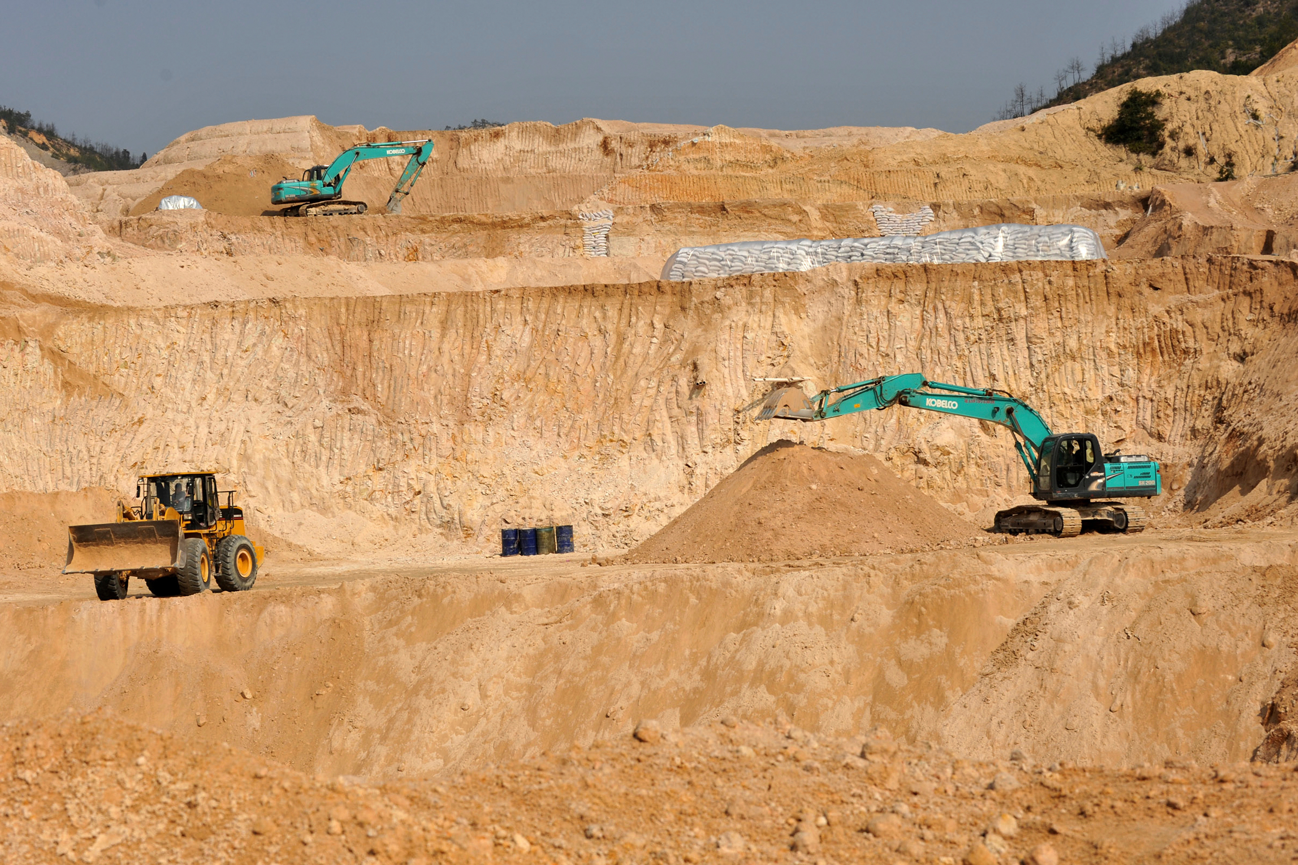 Workers use machinery to dig at a rare earth mine in Ganxian county in central China's Jiangxi province on Dec. 30, 2010.