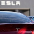 A Tesla model Y and other Telsla vehicles sit at a dealership, Wednesday, March 19, 2025, in Kennesaw, Ga.