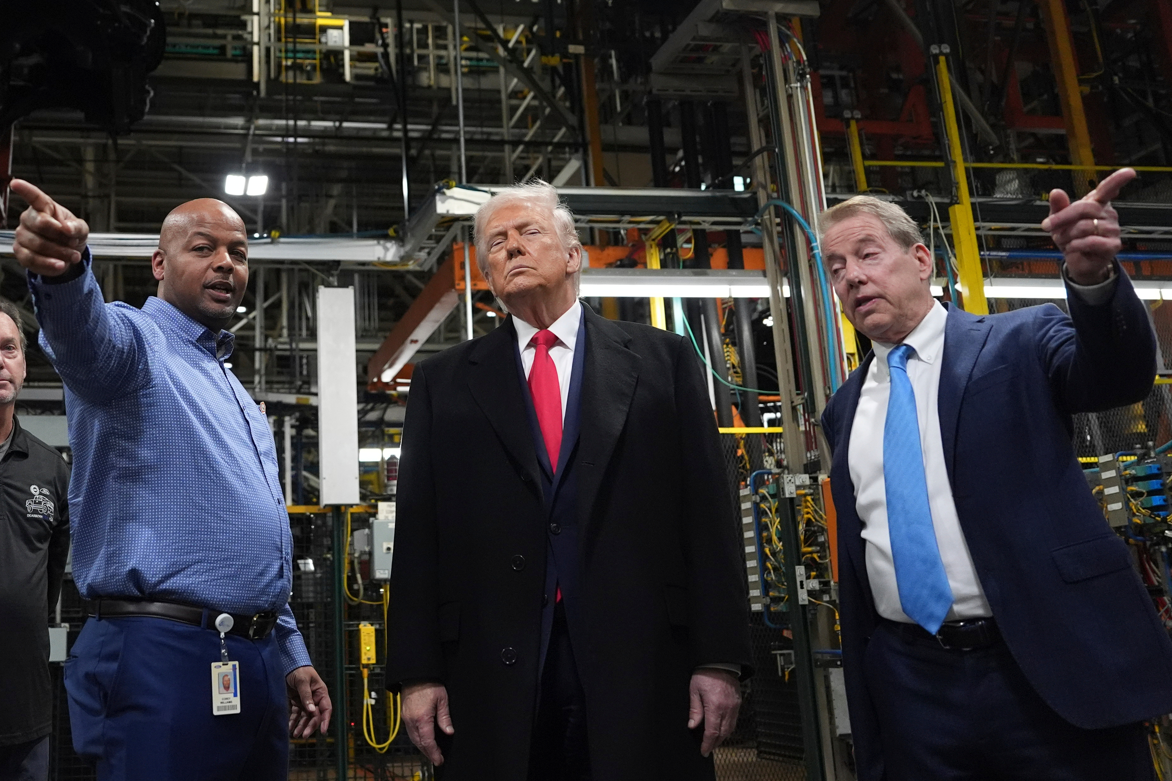 President Donald Trump listens to Corey Williams, Ford River Rouge Plant Manager, left, and Bill Ford, Executive Chairman of Ford, during a tour of the Ford River Rogue complex, Tuesday, Jan. 13, 2026, in Dearborn, Mich.