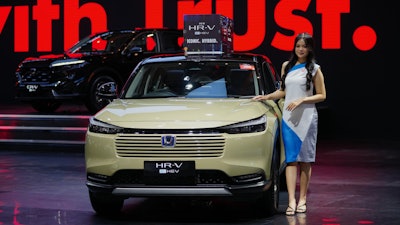 A model poses near a Honda HR-V car during the Indonesian International Motor Show in Jakarta, Indonesia, Thursday, Feb. 5, 2026.