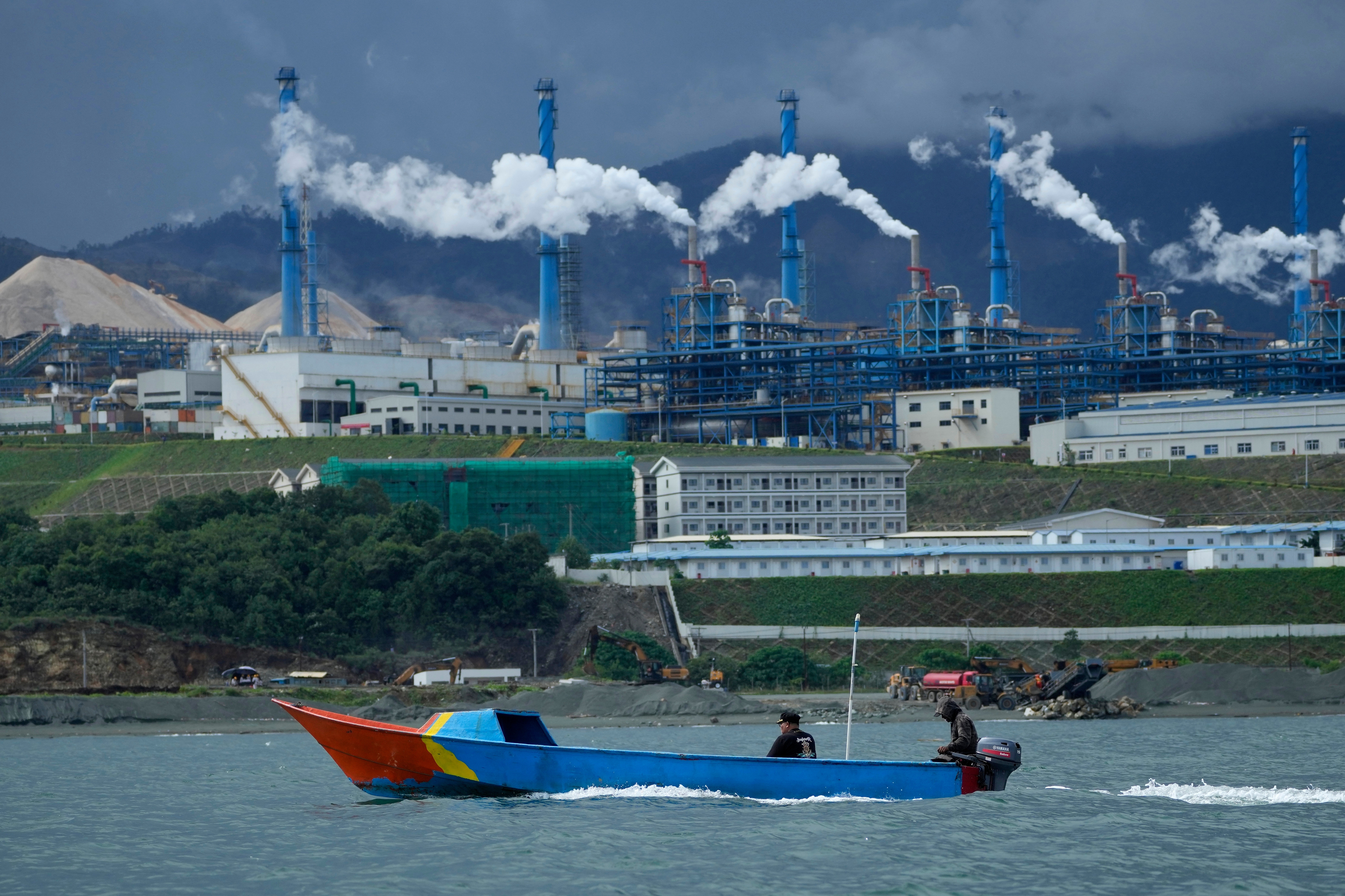 A boat cruises past a nickel processing plant at Indonesia Weda Bay Industrial Park in Central Halmahera, North Maluku province, Indonesia, June 8, 2024.