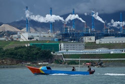 A boat cruises past a nickel processing plant at Indonesia Weda Bay Industrial Park in Central Halmahera, North Maluku province, Indonesia, June 8, 2024.