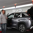 Visitors walk by a hybrid car at a BYD showroom in Beijing, China, Thursday, March 26, 2026.