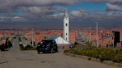 Simón Huanca drives his electric vehicle through the streets of El Alto, Bolivia, Friday, April 24, 2026.