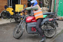 A rider sits on an electric Spiro motorcycle in Nairobi, Kenya, Tuesday, Feb. 24, 2026.