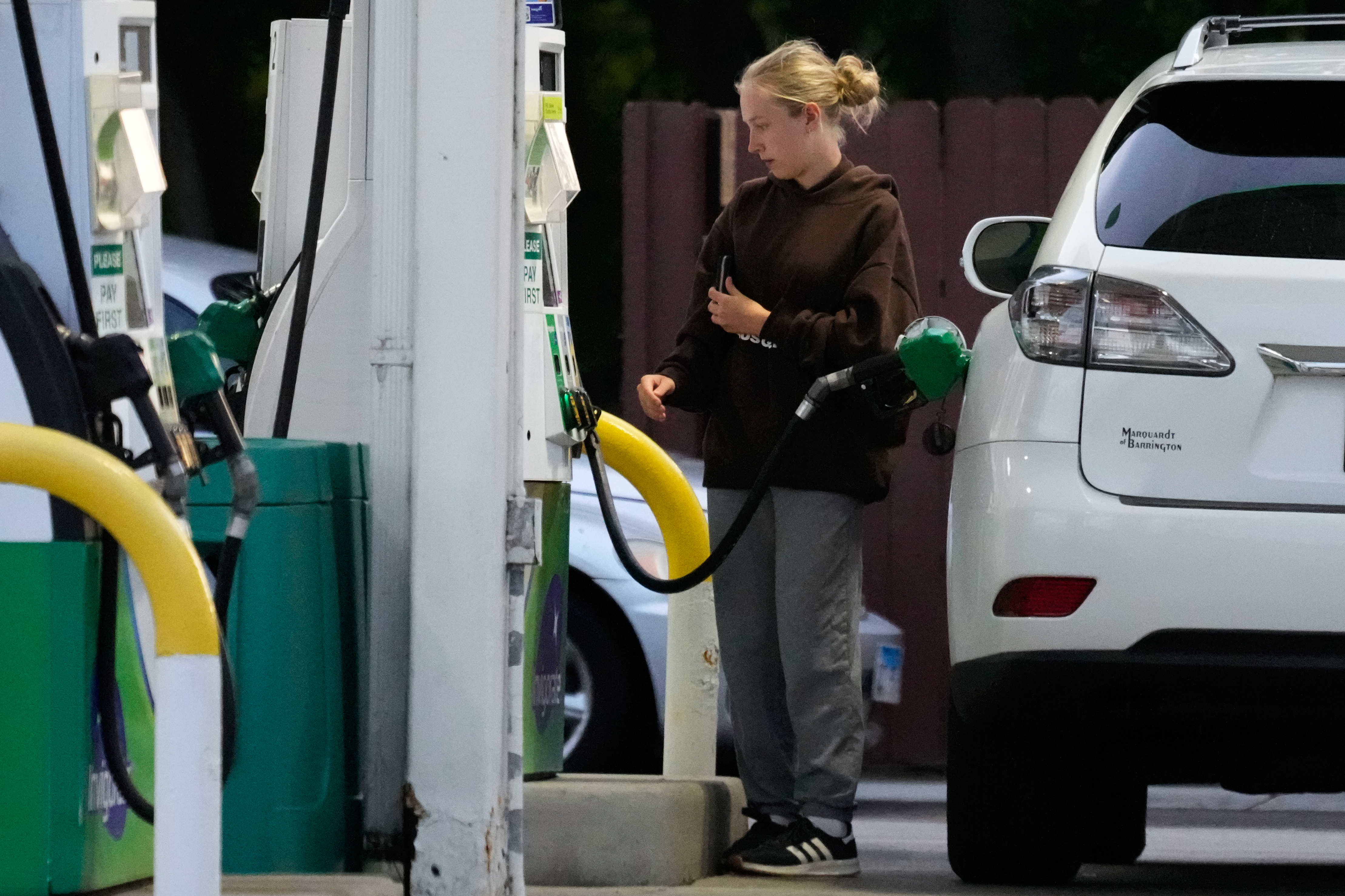 Customer checks gas price before she fills up her vehicle's tank at a gas station in Lincolnshire, Ill., Monday, June 8, 2026.