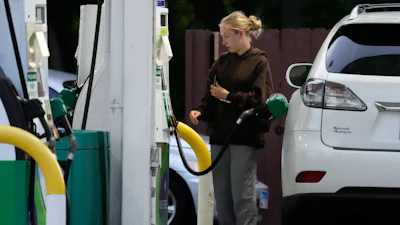 Customer checks gas price before she fills up her vehicle's tank at a gas station in Lincolnshire, Ill., Monday, June 8, 2026.