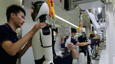 Workers assemble robot at the LY iTech Beijing Super Factory for Embodied Artificial Intelligence during a media tour in the Beijing E-Town on the outskirts of Beijing on May 29, 2026.
