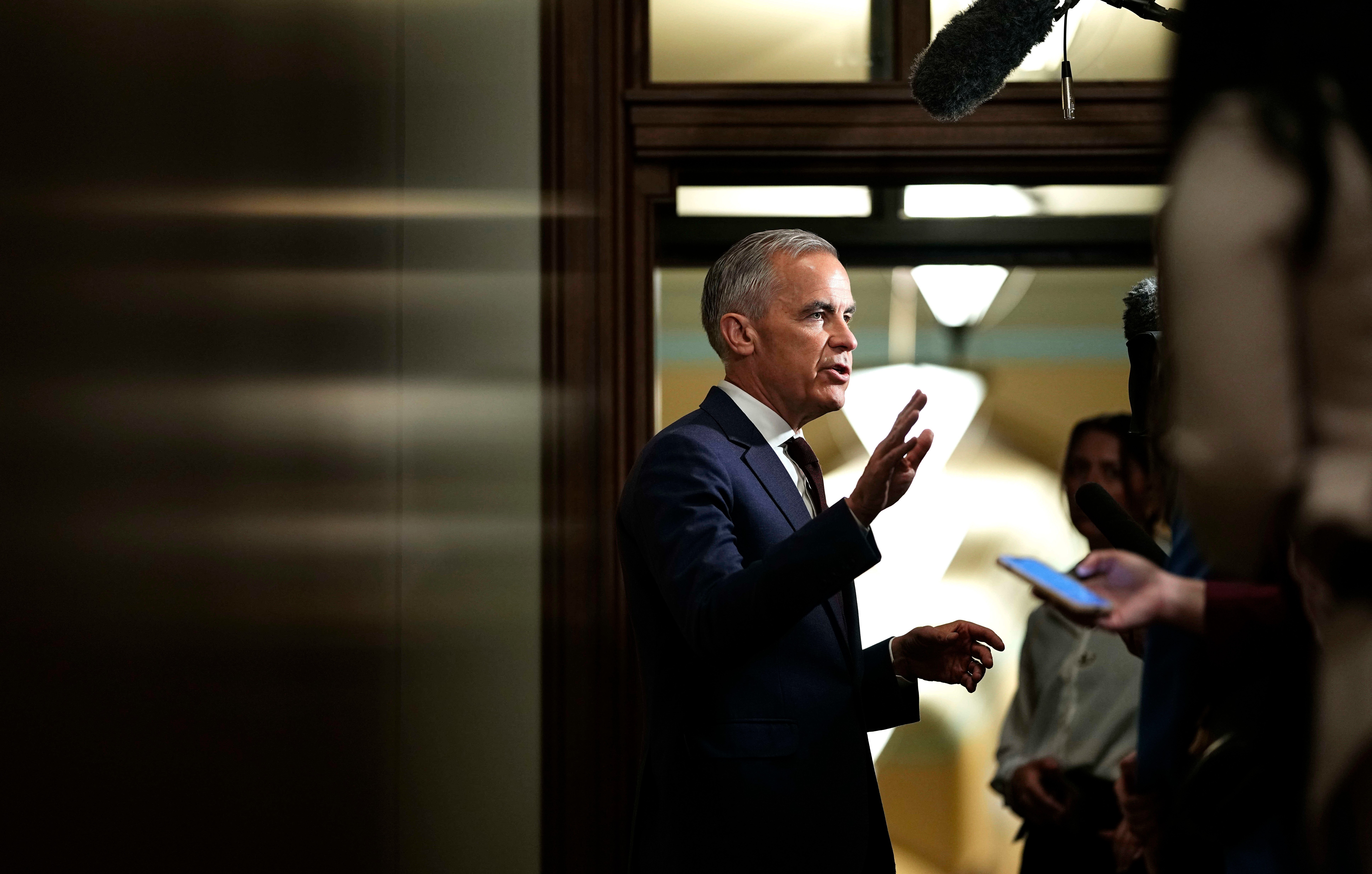 Canadian Prime Minister Mark Carney takes questions from journalists as he arrives on Parliament Hill in Ottawa, June 2, 2026.