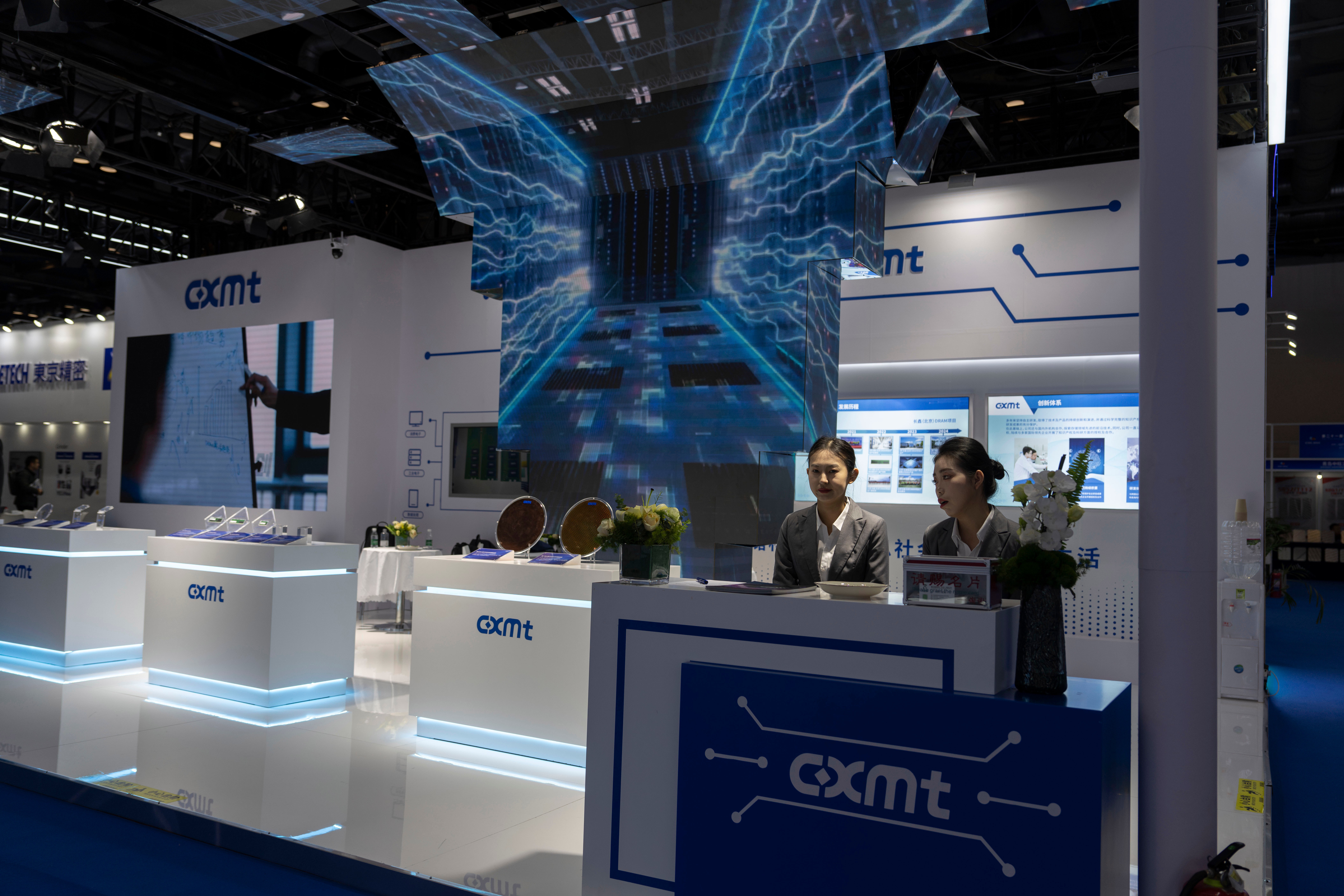 Workers at the booth for Chinese DRAM producer ChangXin Memory Technologies, also known as CXMT, wait for visitors at the 21st China International Semiconductor Expo in Beijing, Nov. 20, 2024.