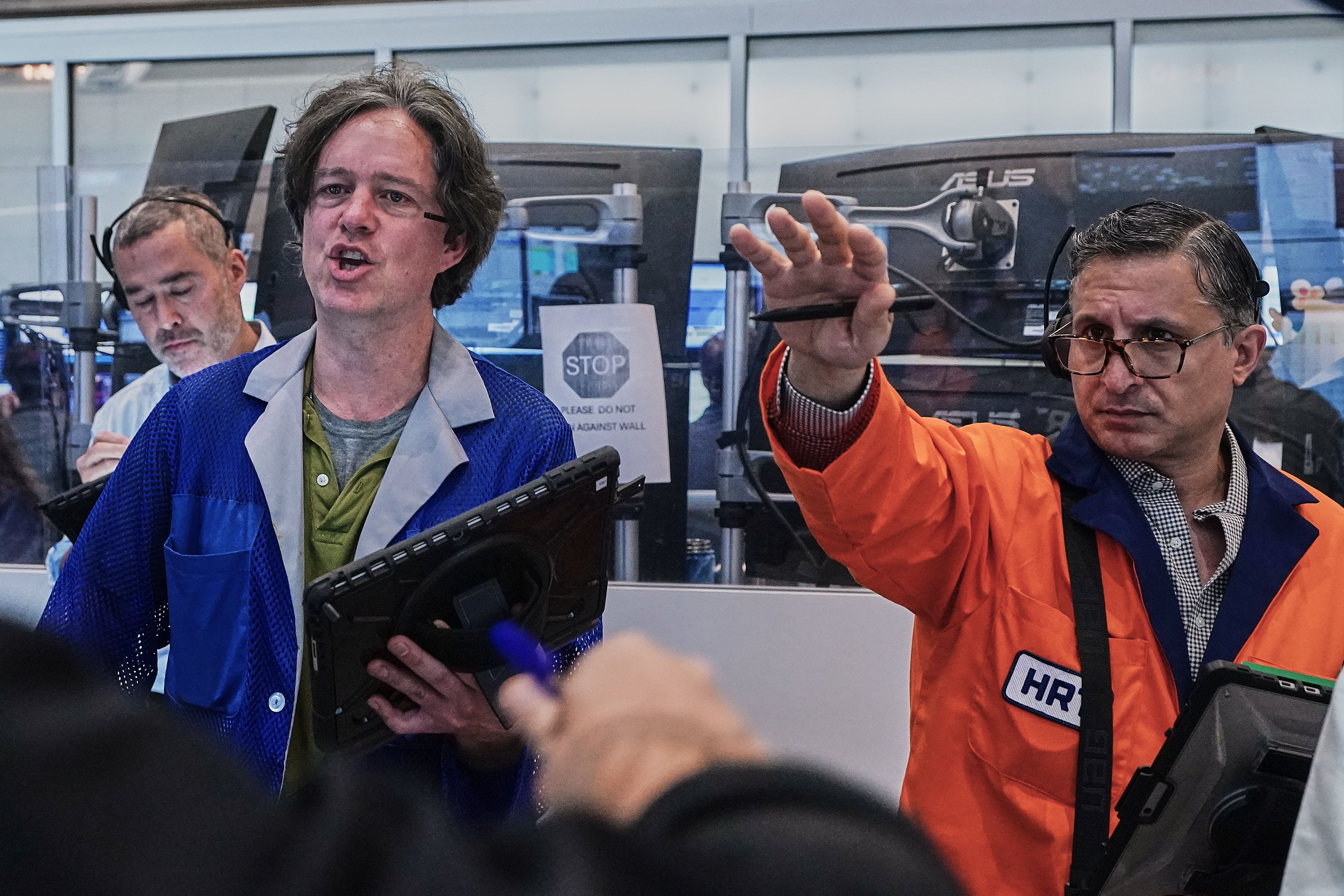 Options traders Justin Kanda, Doran Swan and Ravi Bhandari (left to right) work on the floor of the New York Stock Exchange, Thursday, June 25, 2026.