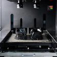 A vat photopolymerization process fabricates a component by curing liquid resin layer by layer using light.