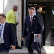 United States Trade Representative Jamieson Greer, center, leaves the U.S. Department of Commerce following a meeting with Canadian officials, Aug. 17, 2026.
