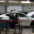 People work on the Tesla Model Y production line at the Tesla Gigafactory assembly plant during a media organized tour, in Shanghai, China, Tuesday, April 14, 2026.