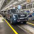 A GMC Sierra EV with battery cells made from recycled materials rolls off the line at GM’s Factory ZERO assembly facility.